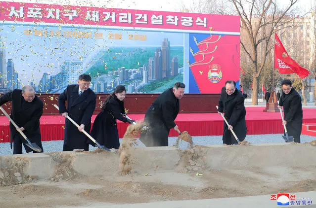 This photo taken on February 25, 2023 and released on February 26, 2023 by North Korea's official Korean Central News Agency (KCNA) shows North Korean leader Kim Jong Un (3rd R) and his daughter (3rd L) attending the ground-breaking ceremony for the construction of a new street at Sopho area of Pyongyang city. (Photo by KCNA via KNS/AFP Photo)