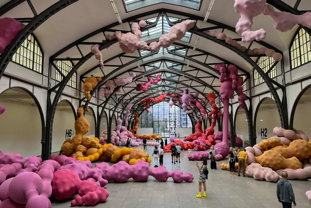 People visit the site-specific installation “Devouring Lovers” by Spanish artist Eva Fabregas at the historic hall of the Hamburger Bahnhof National Gallery for Contemporary Art in Berlin on July 25, 2023. The exhibition runs from July 6, 2023 until January 7, 2024. (Photo by David Gannon/AFP Photo)