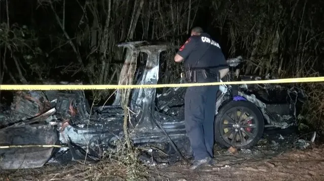 The remains of a Tesla vehicle are seen after it crashed in The Woodlands, Texas, April 17, 2021, in this still image from video obtained via social media. Video taken April 17, 2021. (Photo by Scott J. Engle via Reuters)