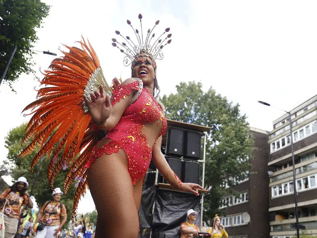 Participants dance along Westbourne Park, during the adults parade, part of the Notting Hill Carnival celebration, in west London, Monday, August 28, 2023. (Photo by James Manning/PA Wire via AP Photo)