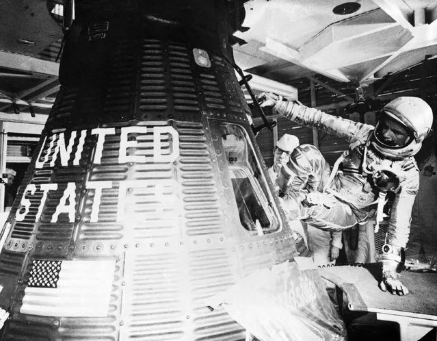 Astronaut John H. Glenn, Jr., pilot of the Mercury-Atlas 6 (MA-6) space flight, enters the Mercury “Friendship 7” spacecraft during the MA-6 pre-launch preparations to begin his historic flight to become the first American to orbit the Earth at Cape Canaveral's Launch Complex 14 in Florida, U.S. on February 20, 1962. (Photo by Reuters/NASA)