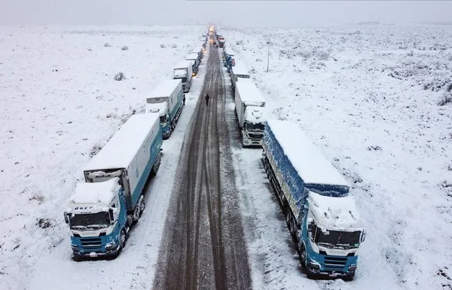 Stranded trucks are seen by the Route 7 as they wait for better climate conditions to cross into Chile through Cristo Redentor international pass, in Pedriel, Mendoza, Argentina on July 15, 2022. (Photo by Maximiliano Rios/Reuters)