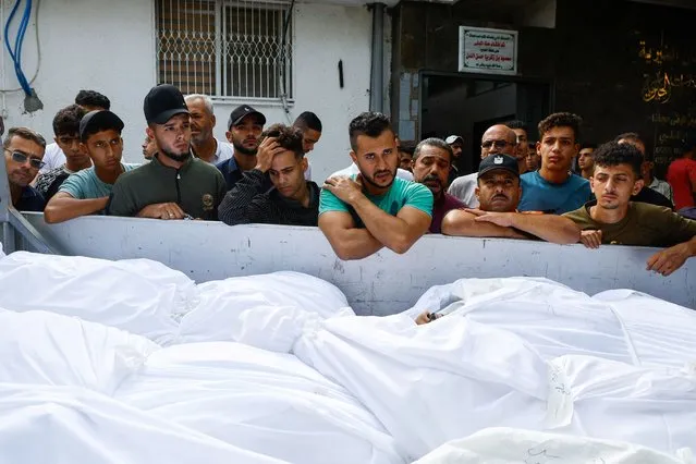 Mourners attend the funeral of Palestinians from the Shamalkh family, who health officials said were killed in Israeli strikes, in Gaza City on October 9, 2023. (Photo by Mohammed Salem/Reuters)