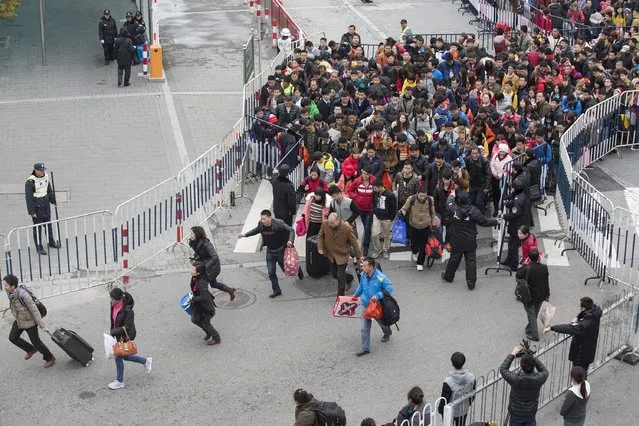 People run to enter Guangzhou Railway Station in Guangzhou, Guangdong province, China, February 2, 2016. More than 50,000 passengers were stranded at a railway station in the Chinese city of Guangzhou on Tuesday because of weather delays, state media said, an inauspicious start for some as the country embarks upon its annual lunar new year travel rush. (Photo by Lin Hongxian/Reuters/Southern Metropolis Daily)