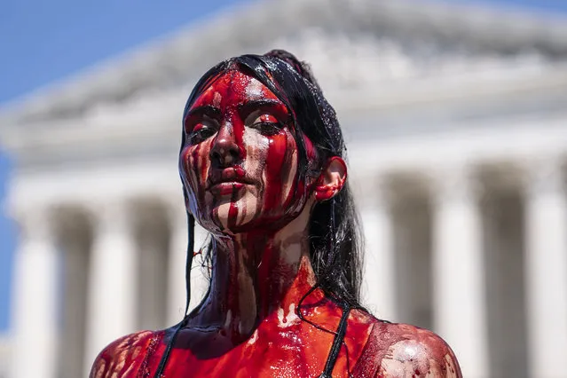 Abortion-rights supporter Sam Scarcello sits in front of the Supreme Court while covered in fake blood on July 4, 2022 in Washington, DC. Protests continued across the country following the Supreme Court's decision overturning Roe v. Wade at the end of June. (Photo by Nathan Howard/Getty Images)