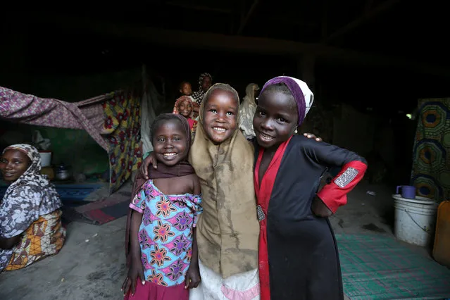 Three girls pose for photograph inside a house occupied by internally displace people at the New Prison camp in Maiduguri, Nigeria November 29, 2016. (Photo by Afolabai Sotunde/Reuters)