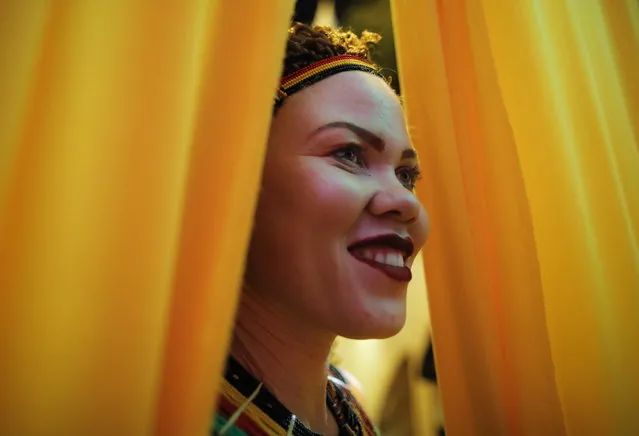 An albino woman looks through the curtain as she prepares for the fashion show during the Mr. & Miss Albinism East Africa contest in Nairobi, Kenya, 30 November 2018. (Photo by Dai Kurokawa/EPA/EFE)