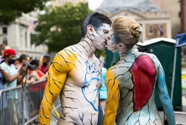 A couple participate during the annual NYC Bodypainting Day at Union Square in New York City, U.S., July 25, 2021. (Photo by Jeenah Moon/Reuters)
