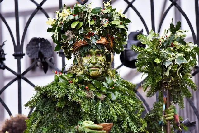 The traditional Twelfth Night Midwinter Celebration takes part at Bankside in London, UK on January 6, 2019. It features the Holly Man, decked in green foliage, being piped over the River Thames. He is joined by the London Mummers, to toast (wassail) the people, and perform freestyle folk combat play in colourful costumes. The procession progresses across the river then from Shakespeare's Globe to its final stage at St George Inn, Southwark. (Photo by Imageplotter/Rex Features/Shutterstock)