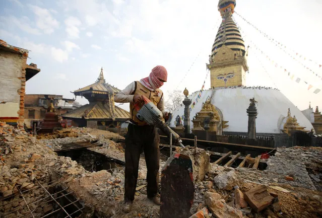 A laborer work to demolish a monastery damaged during the 2015 earthquake, in Swayambhunath Stupa, a UNESCO world heritage site in Kathmandu, Nepal January 11, 2017. (Photo by Navesh Chitrakar/Reuters)