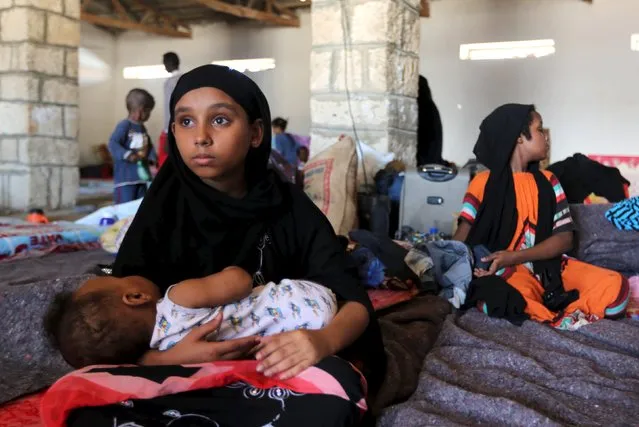 A Yemeni girl holds a baby in a temporary shelter after fleeing violence in Yemen, at the port town Bosasso in Somalia's Puntland April 17, 2015. U.N. Secretary-General Ban Ki-moon on Thursday called for an immediate halt to the fighting in Yemen, the first time he has made such an appeal since Saudi-led air strikes against Iranian-backed Houthi rebels began three weeks ago. (Photo by Feisal Omar/Reuters)