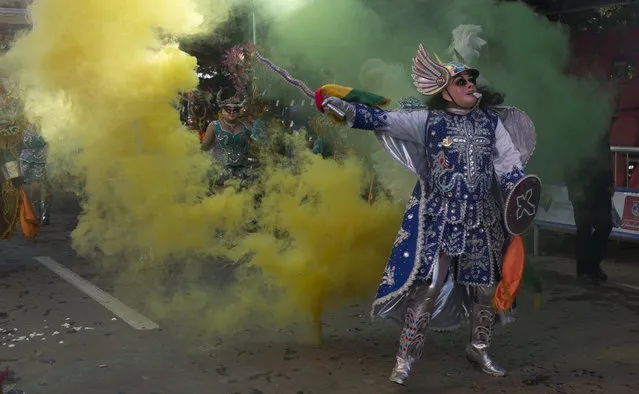 Dancers perform the traditional “Diablada” or Dance of the Devils during the Carnival in Oruro, Bolivia, Saturday, March 2, 2019. The unique festival features spectacular folk dances, extravagant costumes, beautiful crafts, lively music, and up to 20 hours of continuous partying with lots of tourists, drawing crowds of up people annually. (Photo by Juan Karita/AP Photo)