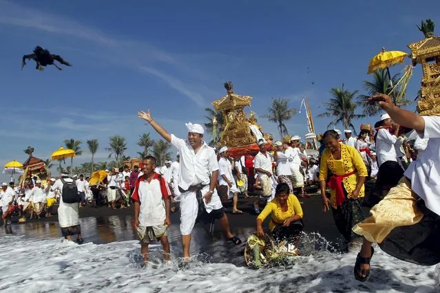 A Balinese Hindu throws a duck into the ocean as a sacrifice during Melasti, a purification ceremony, ahead of the holy day of Nyepi, in Gianyar on the Indonesian resort island of Bali,  March 6, 2016. (Photo by Roni Bintang/Reuters)