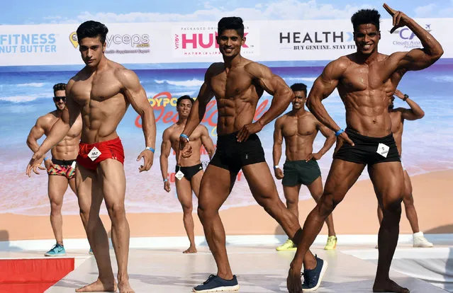 In this picture taken on March 16, 2019, Indian fitness models perform on stage during the “Body Power Beach Show”, India's first beach body carnival, in Goa. (Photo by AFP Photo/Stringer)