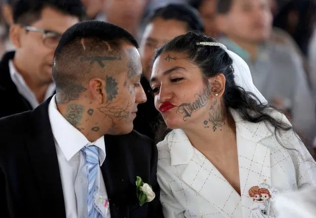 A couple kisses during a massive Valentine's Day wedding in Ciudad Nezahualcoyotl, Mexico on February 14, 2024. (Photo by Luis Cortes/Reuters)