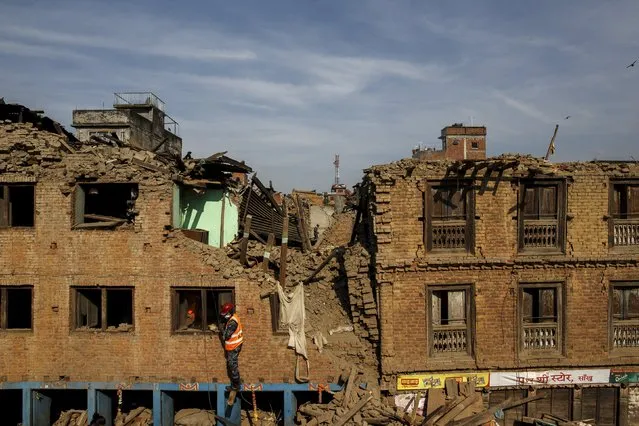 Nepalese military personnel climb up a collapsed house in Sankhu, on the outskirts of Kathmandu, Nepal, May 5, 2015. (Photo by Athit Perawongmetha/Reuters)