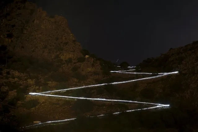 Trails of headlamps are seen in the night as runners descend a mountain as they make their way to the finish line during the XVIII 101km international competition on the outskirts of Montejaque, southern Spain, May 10, 2015. (Photo by Jon Nazca/Reuters)