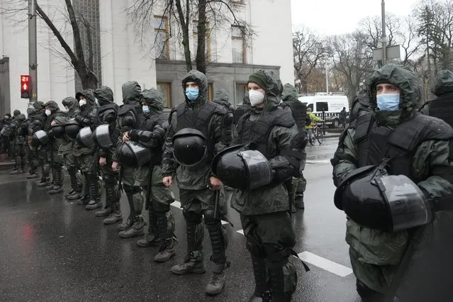 Riot police block an area to protect against demonstrators gathered for an anti-vaccination protest in Kyiv, Ukraine, Wednesday, November 3, 2021. (Photo by Efrem Lukatsky/AP Photo)