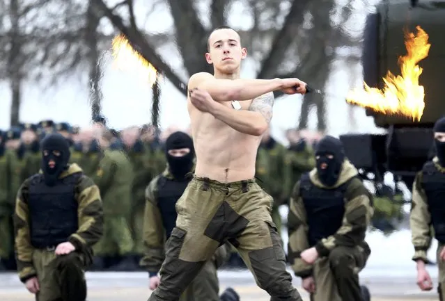 A serviceman of the Belarussian Interior Ministry's special forces unit performs during Maslenitsa celebrations, a pagan holiday marking the end of winter  celebrated with pancake eating and shows of strength, at their base in Minsk, Belarus February 19, 2017. (Photo by Vasily Fedosenko/Reuters)