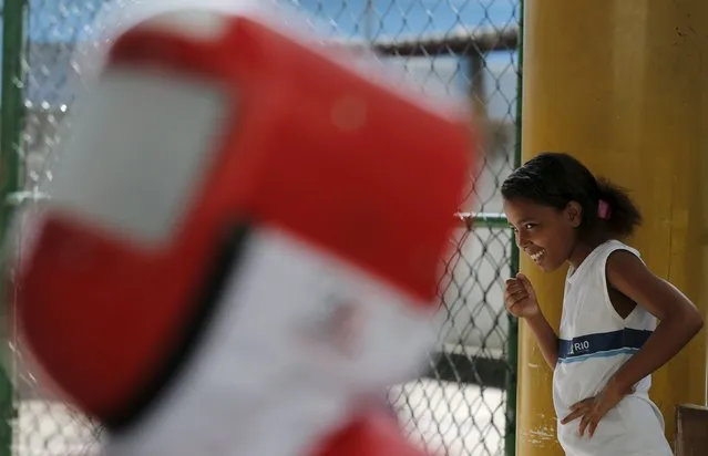A child from municipal school Parana smiles during the project “Fencing School” in Rio de Janeiro, Brazil, March 30, 2016. (Photo by Sergio Moraes/Reuters)