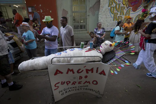 A fake mummy representing the Supreme Court carries a sign criticizing court justices that reads in Portuguese: “The Supreme Mummy. Little causes. Big transactions”, during the Nise da Silveira Mental Health Institute carnival parade, coined in Portuguese: “Loucura Suburbana”, or Suburban Madness, in the streets of Rio de Janeiro, Brazil, Thursday, February 23, 2017. (Photo by Silvia Izquierdo/AP Photo)