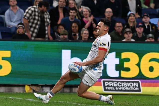 Chiefs' Shaun Stevenson reacts in muscular pain as he scores a try during the Super Rugby match between the NSW Waratahs and the Chiefs in Sydney on April 26, 2024. (Photo by Saeed Khan/AFP Photo)