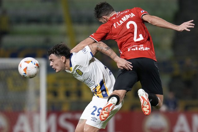 Luca Martinez of Argentina's Rosario Central, left, and Francisco La Mantia of Venezuela's Caracas FC go for a header during a Copa Libertadores Group G soccer match at the Universidad Central stadium in Caracas, Venezuela, Tuesday, April 23, 2024. (Photo by Ariana Cubillos/AP Photo)