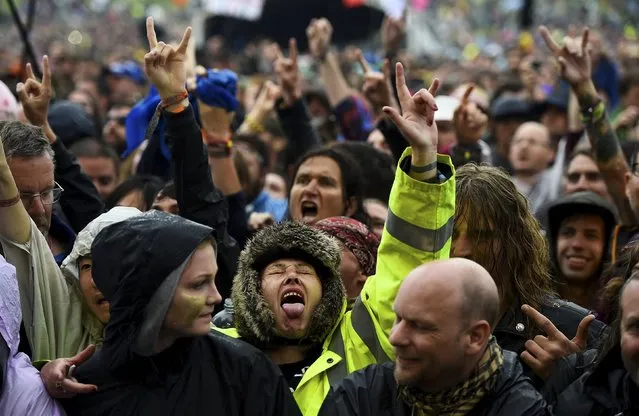 Revellers dance as they listen to Motorhead perform on the Pyramid stage during the Glastonbury Festival at Worthy Farm in Somerset, Britain, June 26, 2015. (Photo by Dylan Martinez/Reuters)