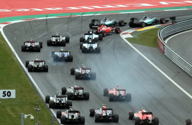 Drivers steer their cars at start of the Austrian Formula One Grand Prix race in Spielberg, southern Austria, Sunday, June 21, 2015. (AP Photo/Ronald Zak)