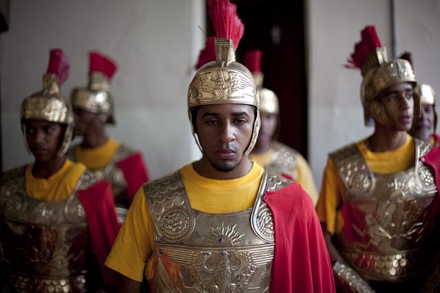 A group of men dressed as Roman soldiers participate in the celebrations of Palm Sunday in Santo Domingo, Dominican Republic, 13 April 2014. The Palm Sunday is marked by Roman Catholic devotees all over the world and starts the Christian Holy Week. (Photo by Orlando Barria/EPA)