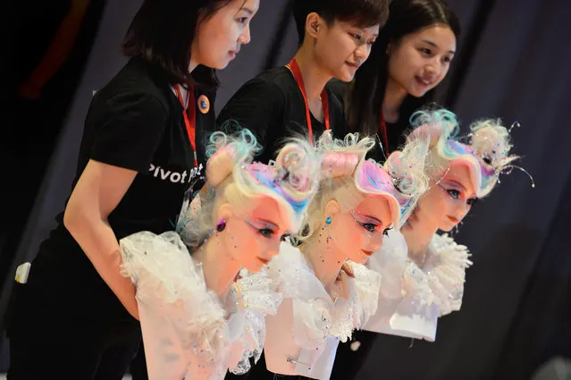 Hairdresser from Taiwan pose with their dolls at the OMC Hairworld World Cup on May 4, 2014 in Frankfurt am Main, Germany. The OMC Hairworld World Cup will be held in Frankfurt from 3 to 5 May 2014, parallel to the Hair and Beauty 2014 fair. (Photo by Thomas Lohnes/Getty Images)