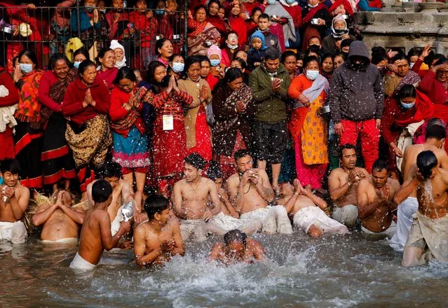 Devotees take holy bath and offer prayers on the bank of the Hanumante river during the final day of the month-long Swasthani Brata Katha festival in Bhaktapur, Nepal on February 16,2022. (Photo by Monika Deupala/Reuters)