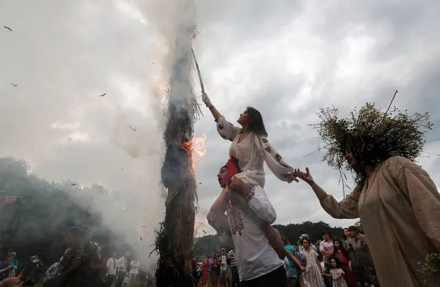 Ukrainians burn straw pillars as they celebrate the traditional pagan holiday of Ivana Kupala in Kiev, Ukraine, 06 July 2021. Ivana Kupala is celebrated on the shortest night of the year, marking the beginning of summer, and is observed in Ukraine, Belarus, Poland, and Russia. (Photo by Sergey Dolzhenko/EPA/EFE/Rex Features/Shutterstock)