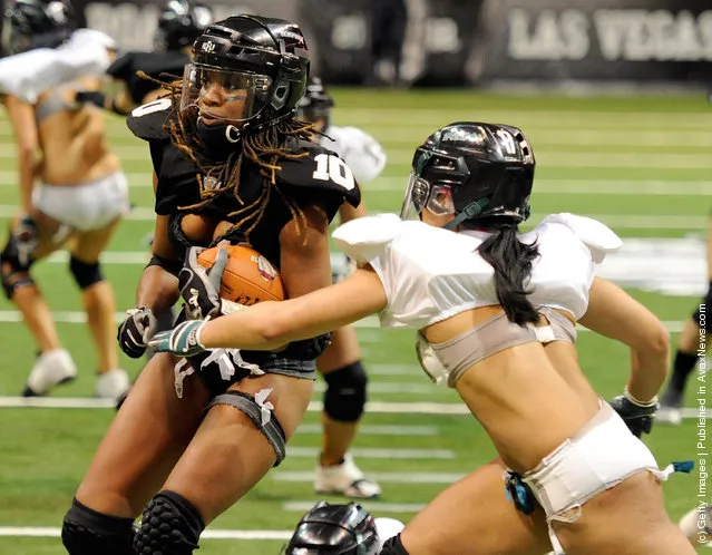 Amber Reed #10 of the Los Angeles Temptation runs for yardage against Shanae Thomas #17 of the Philadelphia Passion during the Lingerie Football League's Lingerie Bowl IX at the Orleans Arena