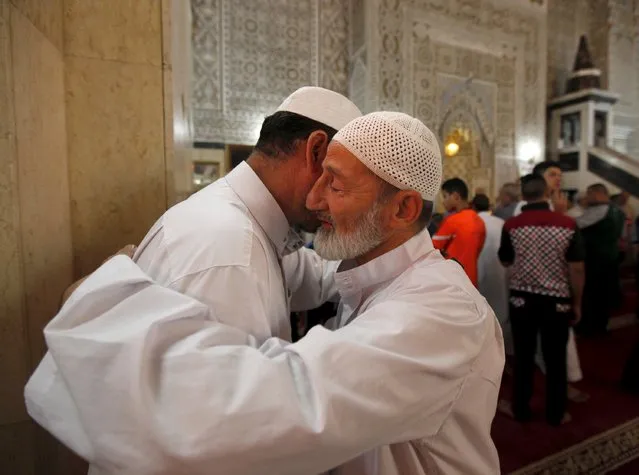 Sunni worshippers exchange greetings after Eid al-Fitr prayers to mark the end of the fasting month of Ramadan at a mosque in Baghdad July 17, 2015. (Photo by Ahmed Saad/Reuters)