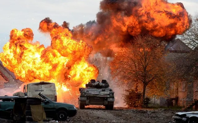 An Warrior tracked armoured vehicle passes an explosion as the British Army demonstrate the latest and future technology used on operations across the globe on Salisbury plain training area on October 29, 2019 in Salisbury, England. (Photo by Finnbarr Webster/Getty Images)
