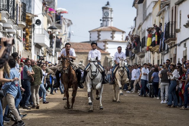 Two men and a boy ride their horses while participating in the Carreras de la Luz on April 10, 2023 in Arroyo de la Luz, Spain. Arroyo de la Luz celebrates the Day of the Light every Easter Monday in honour of its Patron, Saint Nuestra Señora de la Luz. (Photo by Carlos Gil Andreu/Getty Images)