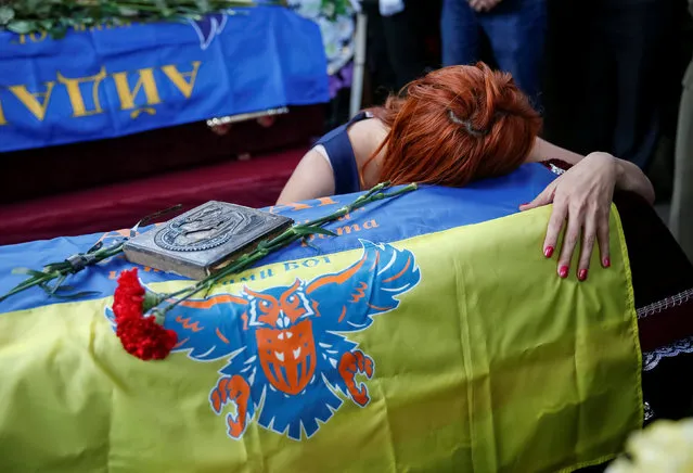 A woman reacts as she attends a funeral ceremony for Mykola Kuliba and Serhiy Baula, servicemen from the “Aydar” battalion, who were killed in the fighting in eastern Ukraine, at Independence Square in central Kiev, Ukraine, May 26, 2016. (Photo by Gleb Garanich/Reuters)