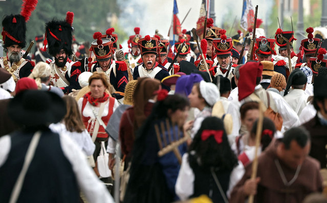 Enthusiasts re-enact the rebellion of the citizens of Madrid on May 2, 1808 against the French troops of Napoleon, in front of the Royal Palace of Madrid on April 30, 2023. (Photo by Thomas Coex/AFP Photo)