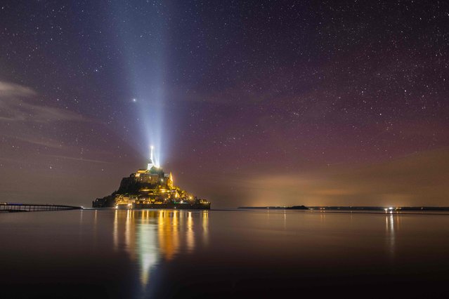 This photograph shows the UNESCO World Heritage site Mont-Saint-Michel at sunset on May 11, 2024. (Photo by Fred Tanneau/AFP Photo)