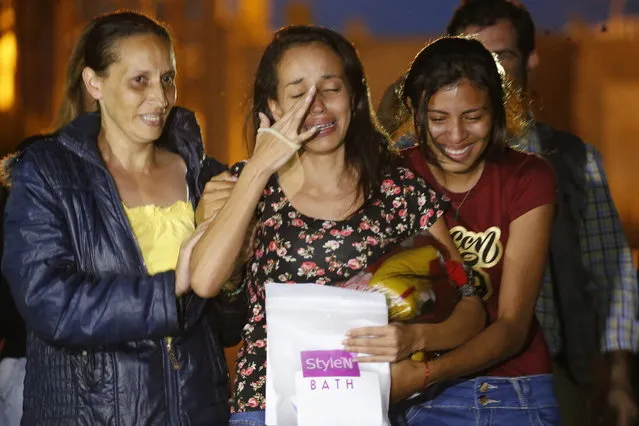 Karen Palacios, center, is helped by family members after she was released from prison at Los Teques on the outskirts of Caracas, Venezuela, Tuesday, July 16, 2019. (Photo by Ariana Cubillos/AP Photo)