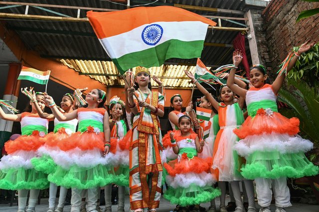 School children carry national flags as they take part in an event on the eve of the India's Independence Day celebrations in Amritsar on August 14, 2024. (Photo by Narinder Nanu/AFP Photo)