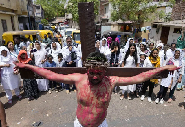 A man reenacts the crucifixion of Jesus Christ to mark Good Friday in Ahmedabad, India, Friday, April 15, 2022. Christians all over the world attend mock crucifixions and passion plays that mark the day Jesus was crucified, known to Christians as Good Friday. (Photo by Ajit Solanki/AP Photo)