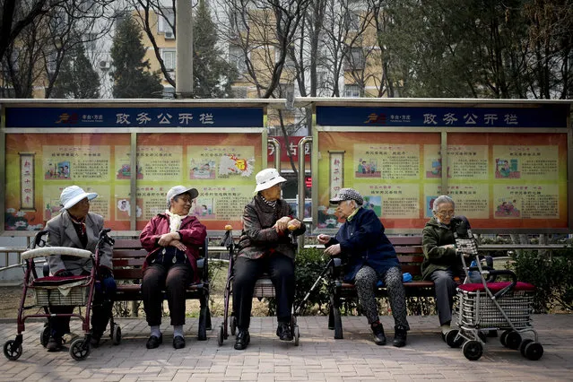 In this March 31, 2016 photo, a group of elderly women rest on their wheelchairs at a residential compound in Beijing. When people over 80 in Beijing take a bus, see a doctor or spend money, their activities are digitally tracked by the government, as part of an effort to improve services for the country's rapidly growing elderly population. The data amassed with each swipe of the multi-purpose “Beijing Connect” old person'�s card goes into a massive database of the elderly in the capital. City authorities hope the information will enable them to better cope with their burgeoning population of over-60s, which already stands at 3 million. (Photo by Andy Wong/AP Photo)