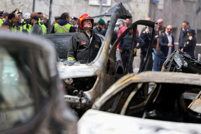 A firefighter works at the site of an explosion in the centre of Milan, Italy on May 11, 2023. (Photo by Claudia Greco/Reuters)