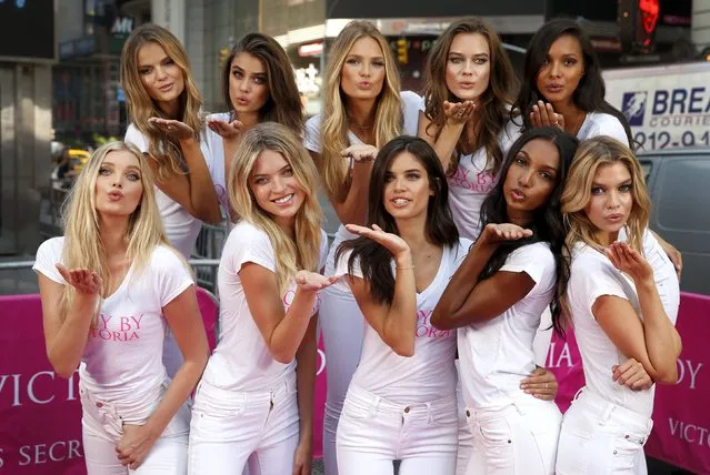 The newest Victoria's Secret “Angels” models pose for photographers in New York's Times Square during the launch of the new “Body by Victoria” campaign July 28, 2015. From L-R front row: Elsa Hosk, Martha Hunt, Sara Sampio Jasmine Tookes and Stella Maxwell. From L-R back row: Kate Grigorieva, Taylor Hill, Rommee Strijd, Jac Jagaciak and Lais Ribeiro. (Photo by Mike Segar/Reuters)