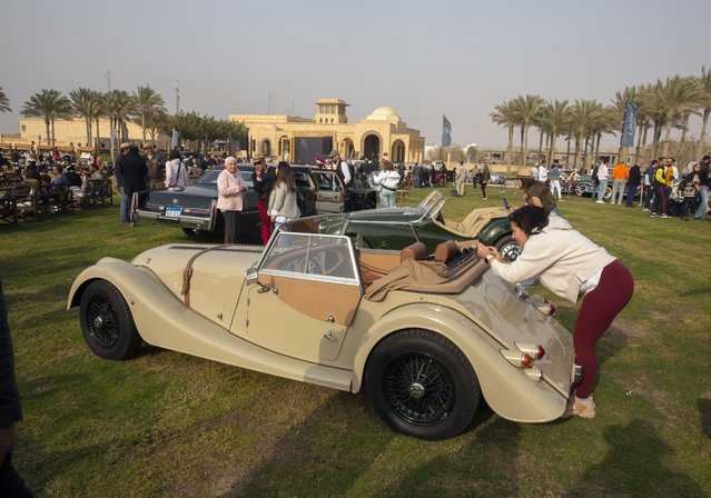 Automobile enthusiasts visit a classic car show in Cairo, Egypt, March 19, 2022. (Photo by Amr Nabil/AP Photo)