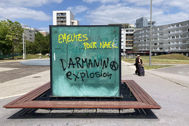 A graffiti reads “Riots for Nahel, Explosion for Darmanin”, refereeing to French Interior Minister Gerald Darmanin, on an urban furniture Sunday, July 2, 2023 in Paris suburb Nanterre. A monument commemorating Holocaust victims and members of the French resistance during World War II was still defaced with graffiti Sunday, after it has been vandalized Thursday on the margins of a silent march to pay tribute to Nahel. Vandals painted anti-police slogans including “Police scum from Saint-Soline to Nanterre”, “Don't forget or forgive”, and “Police, rapists, assassins”. (Photo by Cara Anna/AP Photo)