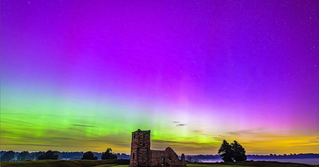 Following an especially strong solar storm on August 8, 2024, the northern lights could be seen above Knowlton Church in Dorset as well as a shooting star. The event is a rare sight so far south in the UK. (Photo by Joseph Anthony/Caters News Agency)