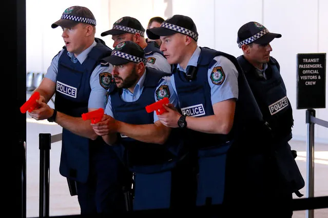 Australian police officers participate in a training scenario called an 'Armed Offender/Emergency Exercise' at an international passenger terminal at Sydney Harbour in Australia, July 27, 2017. (Photo by David Gray/Reuters)